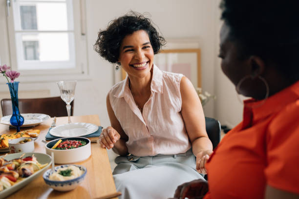 istock Two Beautiful Female Friends Having a Pleasant Conversation at the Dining Table 1657592676