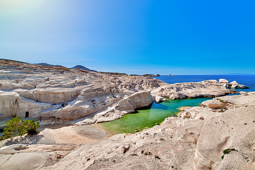 Beautiful landscape of white rocks of Sarakiniko beach, Aegean sea, Milos island , Greece. Empty cliffs, summer day sunshine, clear sea, blue waters, azure lagoon, no people, beautiful landscape, fantastic rocks of tourist destination.