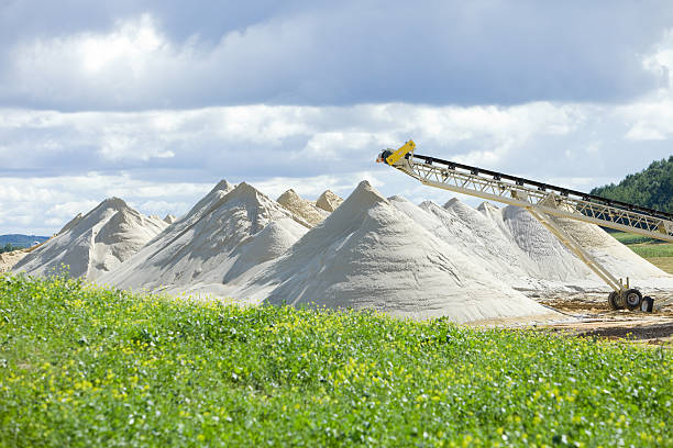 Wisconsin Frac Sand Mine Piles Piles of frac sand at the end of a conveyor at a new Wisconsin mine.  sand mine stock pictures, royalty-free photos & images