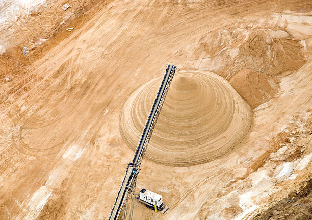 Wisconsin Frac Sand Mine Pile Aerial This is an aerial view of a northwestern Wisconsin frac sand mining operation. A large pile of sand has been deposited by a conveyor. Shot from the open window of a small plane.  http://www.banksphotos.com/LightboxBanners/Aerial.jpg sand mine stock pictures, royalty-free photos & images