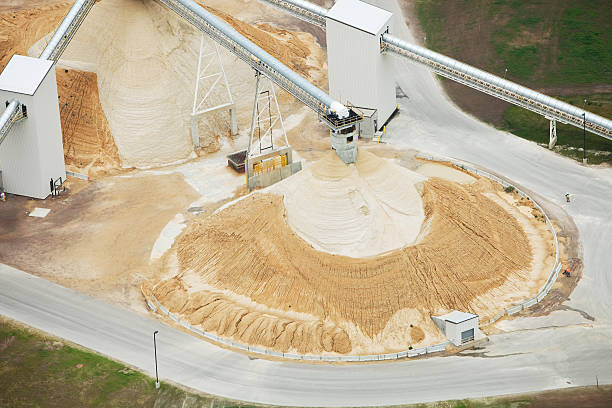 Wisconsin Frac Sand Processing Facility Piles This is an aerial view of a northwestern Wisconsin frac sand processing operation. Large piles of sand have been deposited by enclosed conveyors. Shot from the open window of a small plane. http://www.banksphotos.com/LightboxBanners/Aerial.jpg sand mine stock pictures, royalty-free photos & images