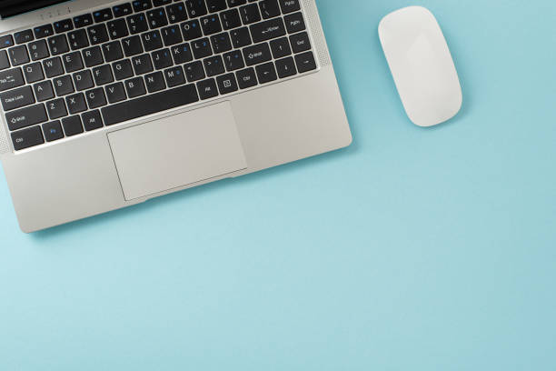 istock Corporate workspace idea. Top view shot photograph displaying laptop, mouse against pastel blue background. Empty space for text or advertisement 1657611268