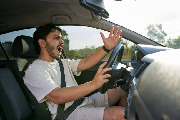 istock Angry young man driving car 1657625945
