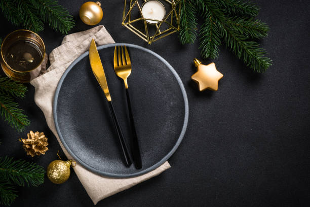 istock Christmas table setting with holiday decorations at black background. 1657627007