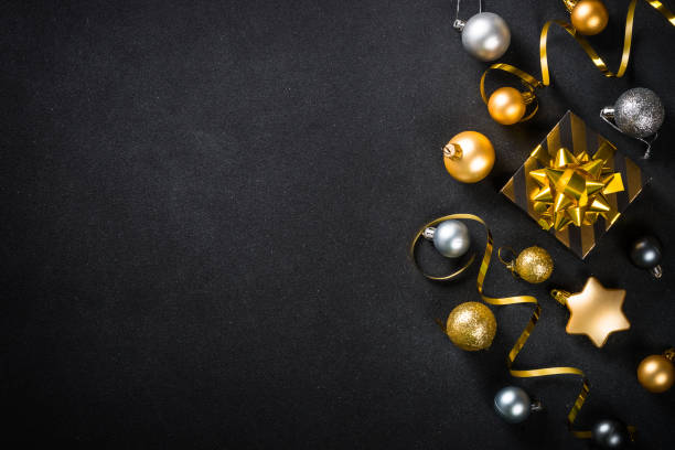 istock Black christmas background with fir tree and holiday decorations. 1657628092