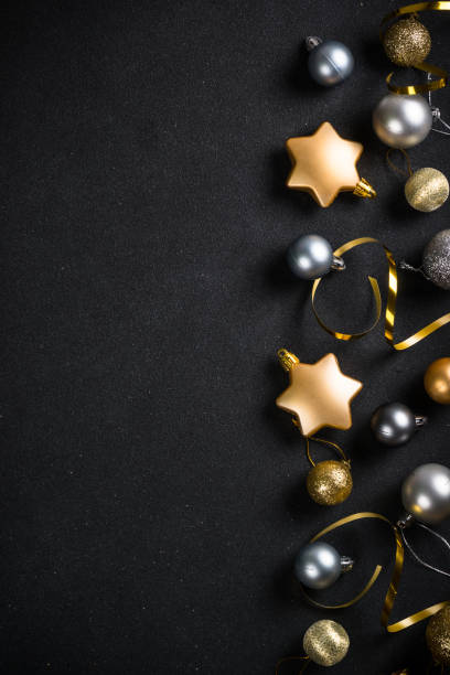 istock Black christmas background with fir tree and holiday decorations. 1657628113