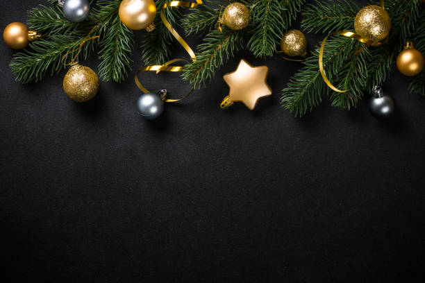 istock Black christmas background with fir tree and holiday decorations. 1657628121