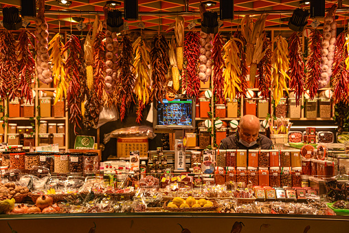 Barcelona, Spain - 23 Nov, 2021: Spices and chilli peppers on sale on a markets stall in the Mercat de la Boqueria, Barcelona, Spain