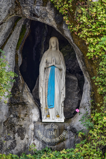 Lourdes, France - 9 Oct 2021: Statue of the Virgin Mary within the Massabielle Grotto in Lourdes