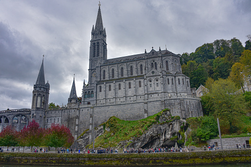 Lourdes, France - 9 Oct 2021: Views of the Rosary Basilica Church from the Gave de Pau river in Lourdes