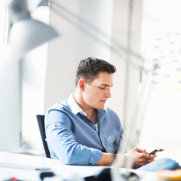 istock Businessman texting on his smart phone 165769736