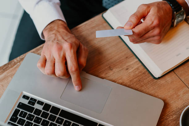 istock Focus on man's hands paying for an online order with a credit card 1657711525