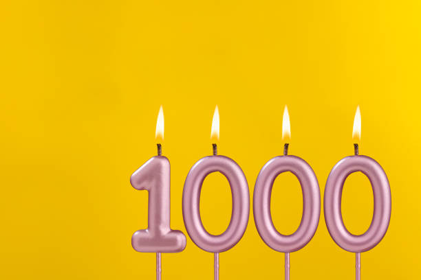 istock Candle 1000 with flame - Birthday card on yellow luxury background 1657742330