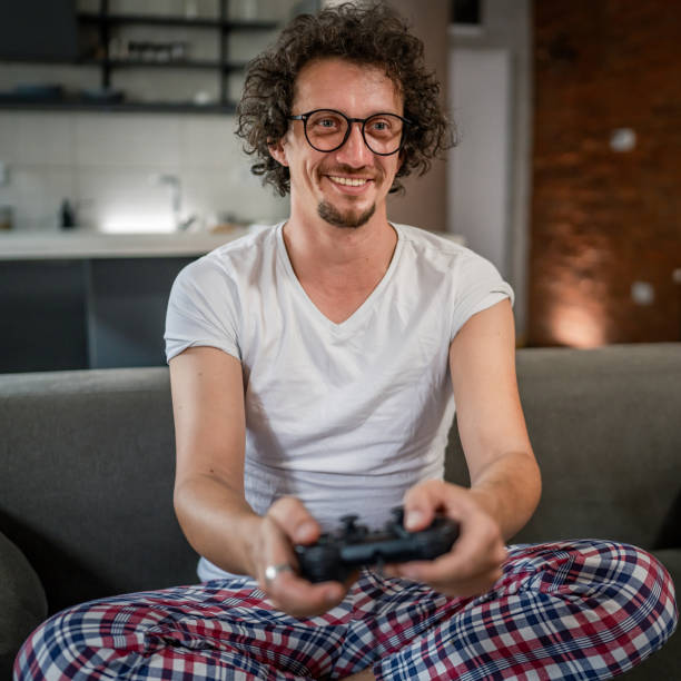 istock man play console video games at home hold joystick controller have fun 1657759384