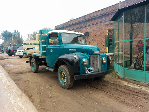 Uribelarrea, Argentina - Jul 15, 2023: old classic 1950s Commer Superpoise Q series British commercial truck flatbed in a road in a countryside town. Copyspace