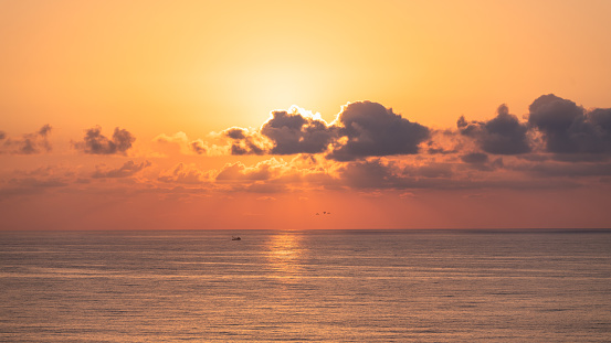 Magnificent sunset over the gentle waves of the warm tropical sea