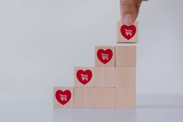 istock Increasing customer loyalty, Customer engagement concept. Building relationships, increase brand awareness, and drive sales. Wooden cube blocks with red hearts and customer loyalty icon on background. 1657804929
