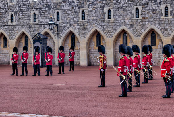 beefeaters and marching bands taking part in the changing of the guard in the lower ward of windsor castle - castle honor guard protection security guard imagens e fotografias de stock