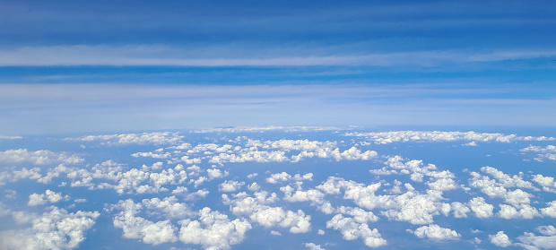 Aerial shot of blue sky with clouds. view from above air plane window.