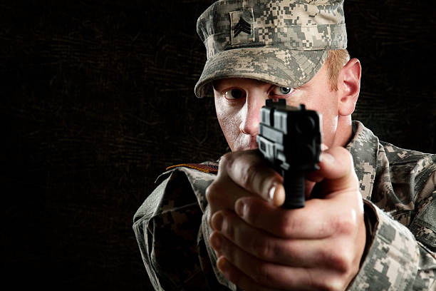 istock American Soldier Series: Young Sergeant Pointing a Gun 165783578
