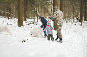 family walking in the winter forest