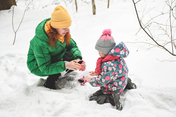 istock mother and daughter walk in the winter forest 1657860937