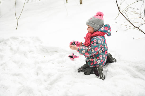 istock girl walking in the winter forest 1657861964