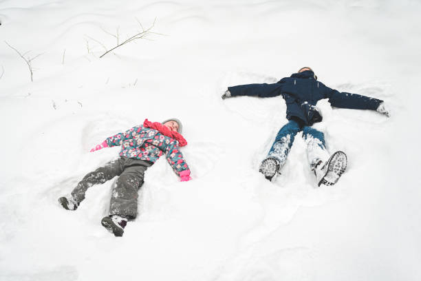 istock sister and brother walk in the winter forest 1657862900