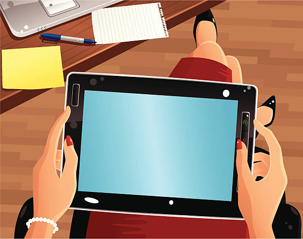 Overhead view of Tablet PC Cartoon style first person view of a typical handheld tablet PC. Around the tablet are some blank papers, a pen and laptop on a desk. Plenty of copy space for your own message. corporate office cubicle stock illustrations
