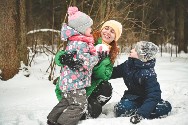 istock family walking in the winter forest 1657876514