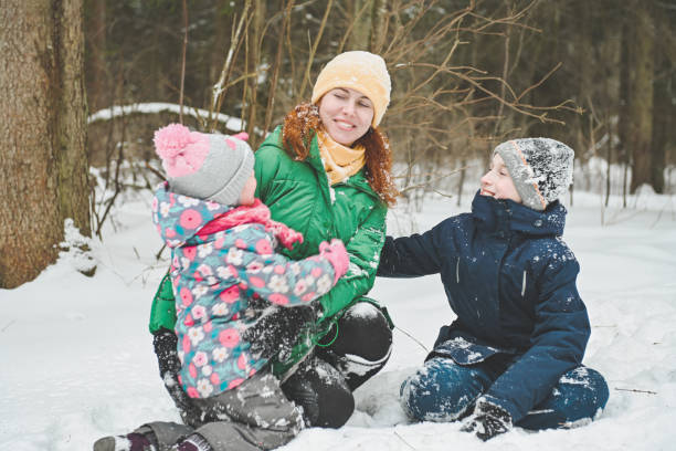 istock family walking in the winter forest 1657878038