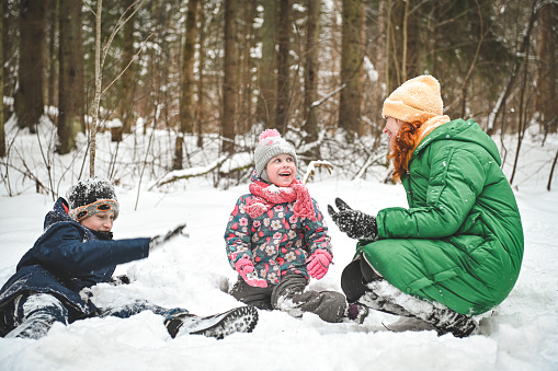 family walking in the winter forest