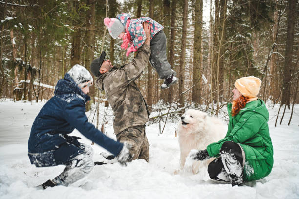 istock family walking in the winter forest 1657882687