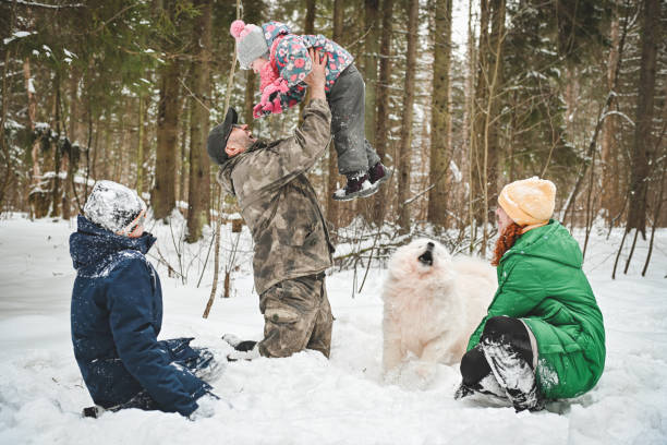 istock family walking in the winter forest 1657882823