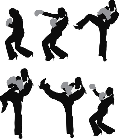 Silhouette of a busineswoman in fighting pose