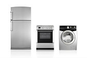 A silver fridge, an oven and dryer lined up side by side
