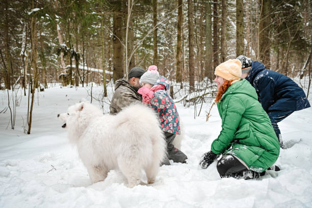 istock family walking in the winter forest 1657897858