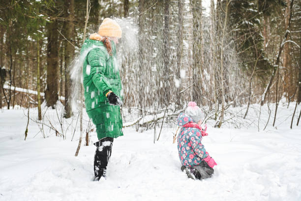 istock mother and daughter walk in the winter forest 1657904679