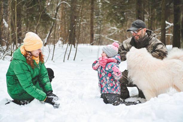istock family walking in the winter forest 1657905231