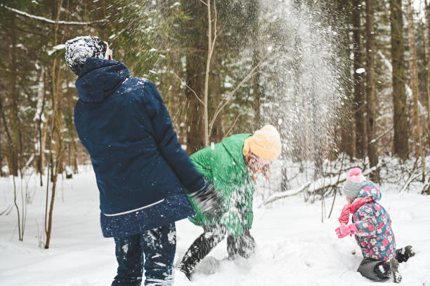 istock family walking in the winter forest 1657905735