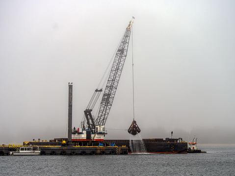 Large Crane Dredging the Winchester Bay along the Oregon coast.