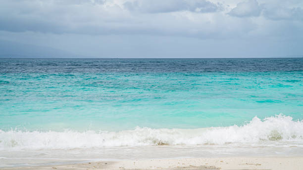 istock dark blue and light blue sea water and small waves on the beach 1657943282