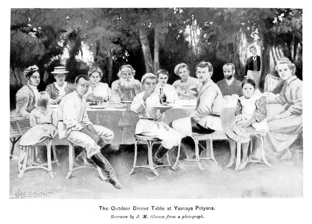 Leo Tolstoy Family Dines Outside with Family, Author, 19th Century Russian Literature and Culture Count Lev Nikolayevich Tolstoy (September 9, 1828 –  November 20, 1910), a Russian author, dines outside at his home with his family. He received multiple nominations for the Nobel Prize in Literature and the Nobel Peace Prize. Photograph engraving  published 1896. The original edition is in my archives. Copyright has expired and is in Public Domain. leo tolstoy stock illustrations