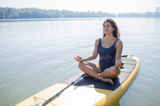 istock Happy young woman is spending time relaxing by the river 1657964449