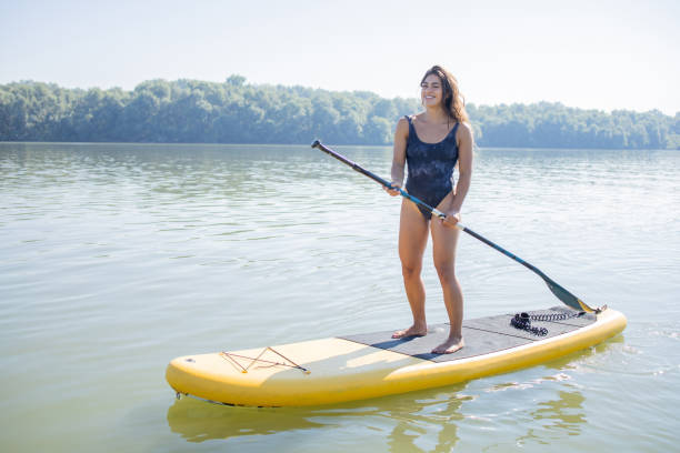 istock Happy young woman is spending time relaxing by the river 1657964462