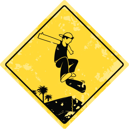 Street skating in it's rawest form, weathered ledge with palm tree skyline set as the backdrop to a complex stylish trick. Warning sign!