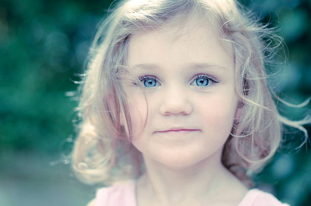 posing little girl with blue eyes - image cross processed