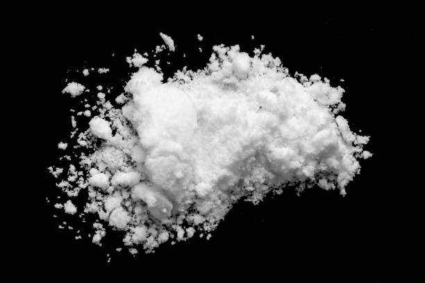istock White snow isolated on black background close up 1657992612