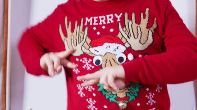 Christmas merry dance with the fingers of a man in a New Year sweater with deer