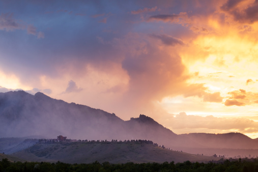 Dramatic scene as fog and smoke from a wildfire drape the Flatirons in Boulder Colorado.